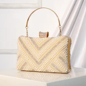 Exquisite pearl rhinestone evening clutch bag with metal round handle for elegant banquets.