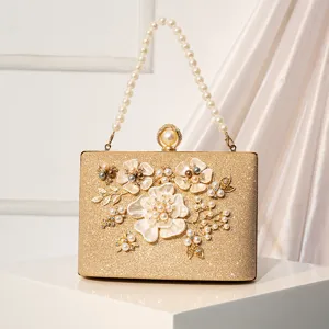 Elegant gold evening clutch bag featuring stunning pearl flower design and pearl handle for women.