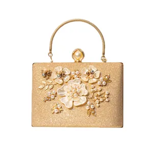Gold glitter evening clutch bag with pearl flower top handle for women wedding party dress.