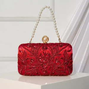 Elegant red embroidered evening clutch bag with pearl handle, perfect for weddings and parties.