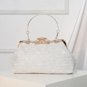 Elegant white lace evening clutch bag with rhinestone metal handle for bridal wedding dresses.