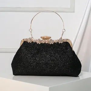 Elegant black glitter evening clutch bag with gold metal frame, rhinestone clasp and round handle.
