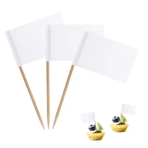 Blank white toothpick flags detail showing paper flags on wooden picks used for cupcake decoration.