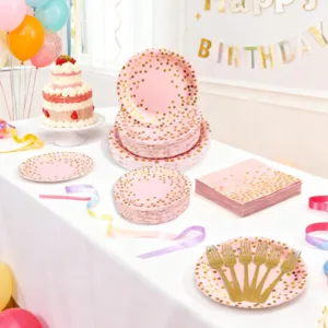 Pink polka dot party paper plates and tableware detail showcasing birthday party decor set.