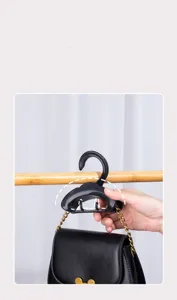 Black arch bag hanger for closet, versatile storage hook for handbags, purses, and belts.
