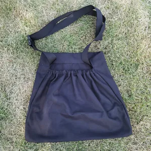 Outdoor black fabric foraging harvest bag detail view with adjustable strap and sturdy.