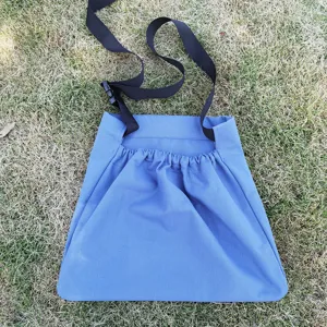 Blue outdoor foraging bag for fruit picking, adjustable black strap, durable fabric.
