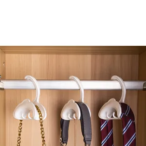 Detail view of white arched multi-functional wardrobe hooks showing practical use for hanging straps.