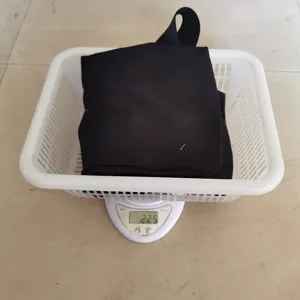 Detail view of the black canvas foraging bag in basket for weight check, showing 225g.
