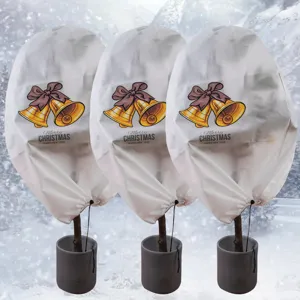 Plant frost protection cover detail, non-woven winter tree protector with Christmas bell print.
