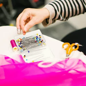 Vue détaillée d'épingles à tête de verre colorée dans une boîte avec accessoires.