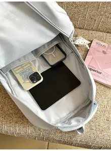 Light blue backpack interior showing multi-compartment storage for tablet and daily items.