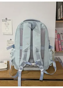 Light blue ergonomic casual backpack with cute bow embroidery, ideal for travel.