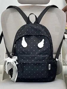 Detailed view of black backpack with cute heart print, white angel wings and lace ribbon.