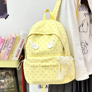 Cute yellow canvas school backpack with angel wings and bow for girls and students.