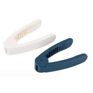 Manual peanut sheller kitchen tool detail view, portable plastic melon seed peeling gadget for home use.