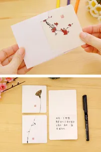 Detail view of Chinese style ink painting greeting card with poetic text and delicate design.