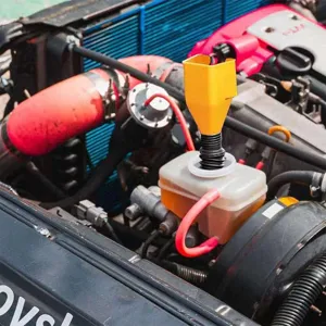 Adjustable automotive fuel funnel for easy oil change and fluid transfer in engine.