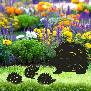 Detail view of cute black hedgehog garden stakes, decorative metal silhouettes for lawn yard art.