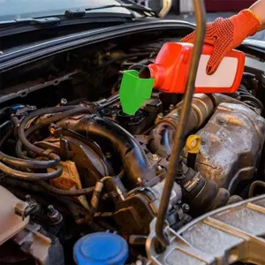 Detail view of adjustable car oil funnel in engine bay, compact design for easy fluid pouring.