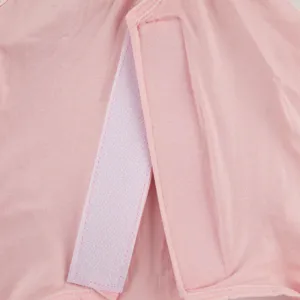 Detailed view of the cat recovery suit hook and loop fastener, soft pink breathable fabric.