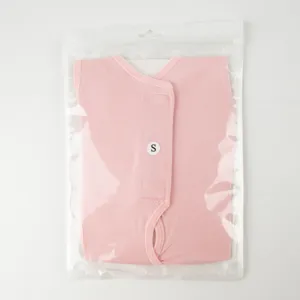 Pink pet post-surgery recovery suit detail, sleeveless cotton cat sterilizing clothing inside bag.
