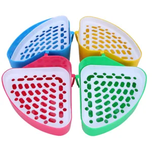 Vista dettagliata della cassetta igienica d'angolo in plastica per conigli con griglia.