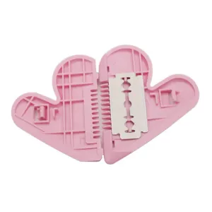 Pink plastic double-sided hair thinning comb and bangs trimmer with razor blade for split ends.