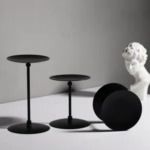 Matte black metal candle holder detail view, minimalist display stand for pillars and home decor.