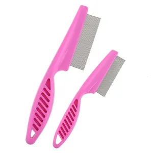 Close up detail of pink plastic handle pet flea comb with fine metal teeth for cats dogs.