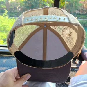 Detailed view of disposable hat sweat pad inside a trucker cap, sweat-absorbing liner.
