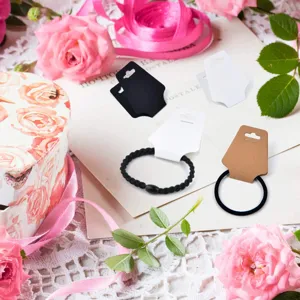 Blank jewelry display cards set with black hair ties, perfect for organizing and showcasing accessories.