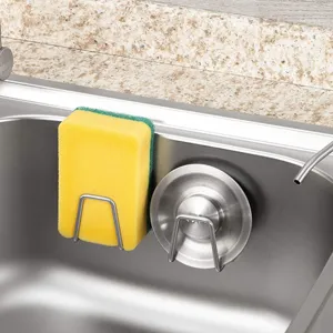 Stainless steel sponge holder detail view showing suction cup mount inside kitchen sink.