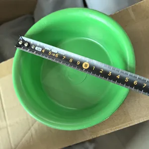 Green plastic utility bowl, durable daily use container measuring basin for household items.
