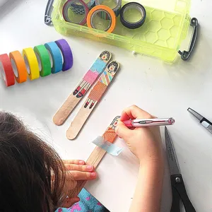Colored popsicle sticks and masking tape for DIY crafts, wooden sticks for school projects.