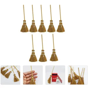 Close-up detail showing miniature natural broom texture, wood handle, and dollhouse scene props.