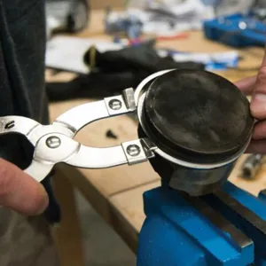 Piston ring expander tool automotive pliers for removing and installing engine rings easily.