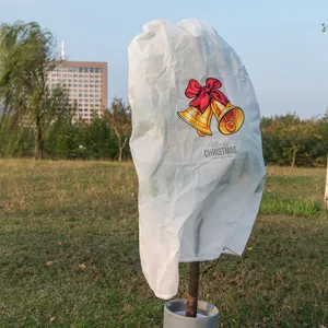 White non-woven plant cover winter frost protection bag with Christmas bell print for outdoor trees