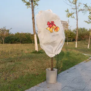 White non-woven plant cover frost protection winter frost proof bag with Christmas bell print.