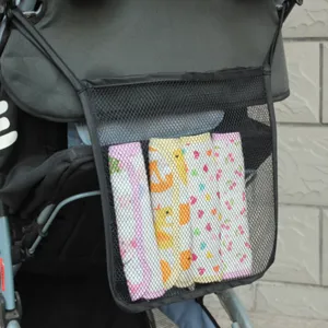 Detailed view of stroller mesh hanging storage bag mounted on pushchair, holding baby items.