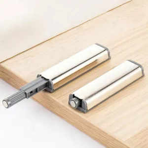 Detail view of magnetic push latch with stainless steel housing for cabinet doors and drawers.