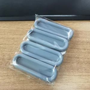 Detail view of grey self-adhesive pull handles, punch-free design for sliding doors.