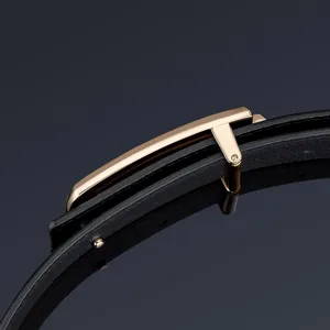 Luxury men's leather belt with polished gold metal buckle and premium black cowhide strap.