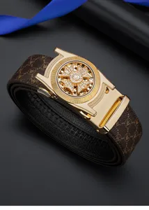 Detail view of men's luxury leather belt featuring a gold automatic buckle with sparkling rhinestones.