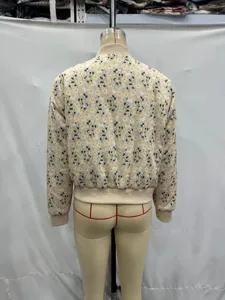 Back view detail of women floral padded jacket showing daisy print and ribbed hem cuff.