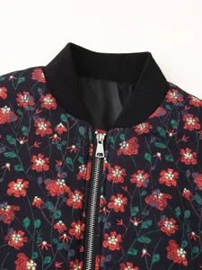 Close-up detail view of women floral print bomber jacket collar and metal zipper.