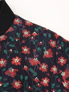 Women floral print padded jacket shoulder detail view, showcasing exquisite pattern.
