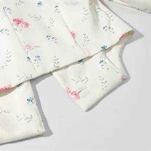 Detailed view of the chic floral printed fabric, elegant resort style suit material texture.