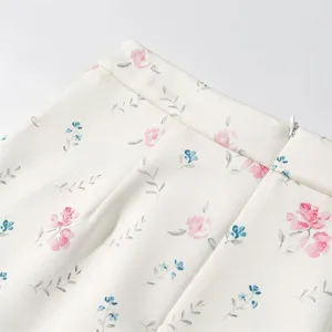 Floral print skirt detail showing delicate pink and blue flowers on soft fabric, elegant style.