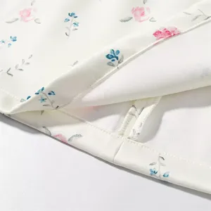 Exquisite floral fabric detail of resort style women skirt set, elegant print and neat stitching.